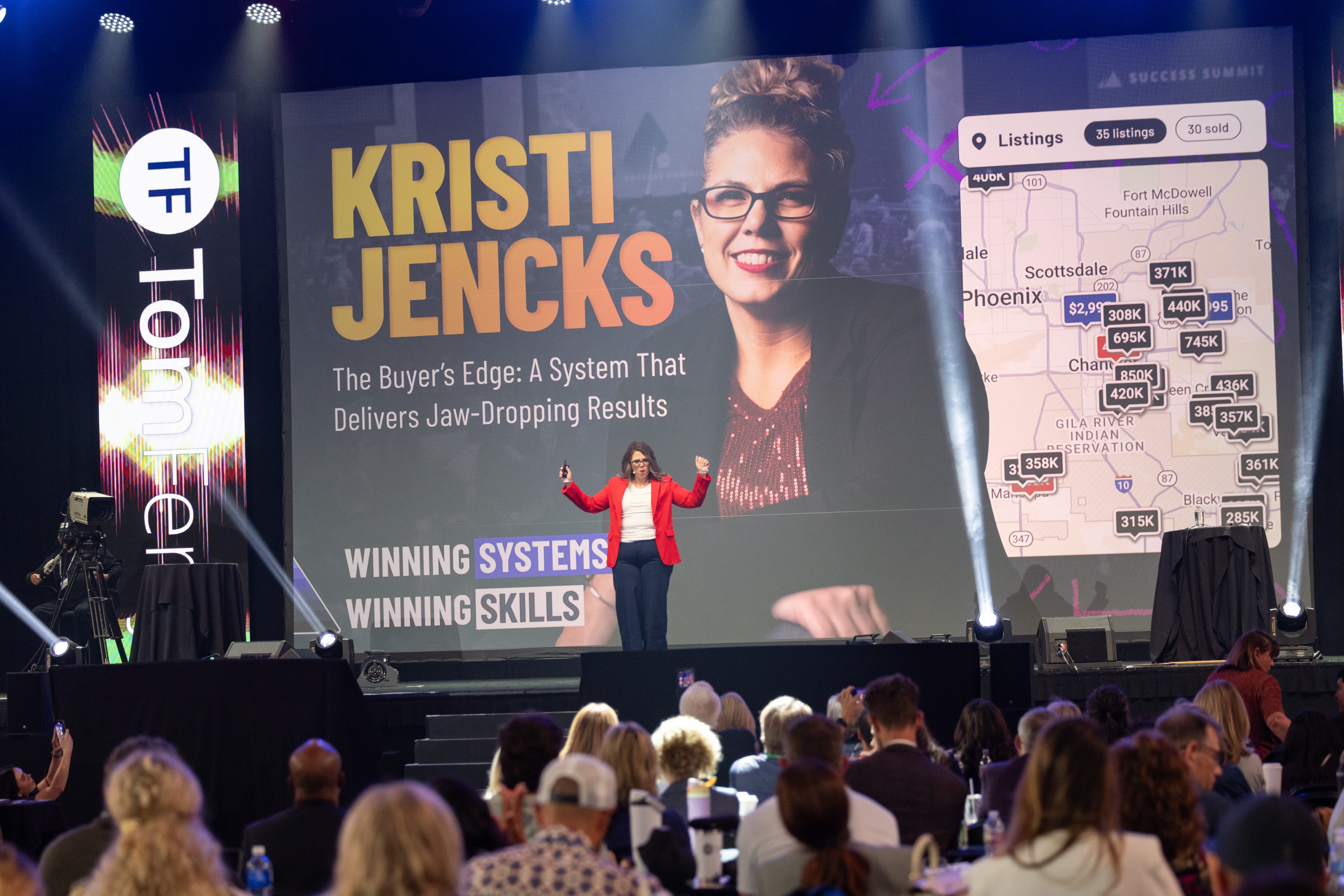 Kristi Jencks presenting at a conference, with a large screen displaying her name and a real estate listing map behind her, emphasizing her system for delivering results.